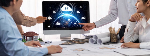 Group of interior architect designer discussing together on blueprint and laptop screen display...