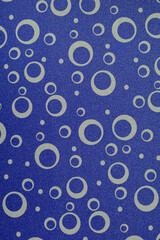 Paper texture with ornament. Decorative cardboard sheet with circles. Blue geometric background	