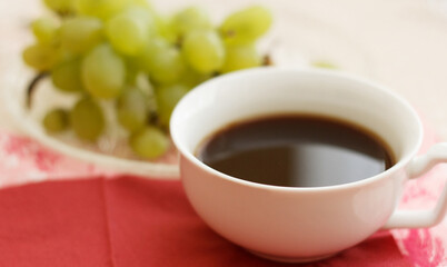 Cup of natural coffee with grapes