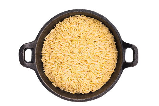 Raw Orzo pasta, uncooked dry Italian risoni in a bowl isolated on white background. top view