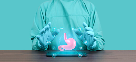 Gastroenterologist with tablet showing an anatomical model and 3D hologram of the stomach and...