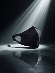 Floating black techwear face mask with laser-cut vents, hyperreal shadow drop below, sharp mirror floor reflection
