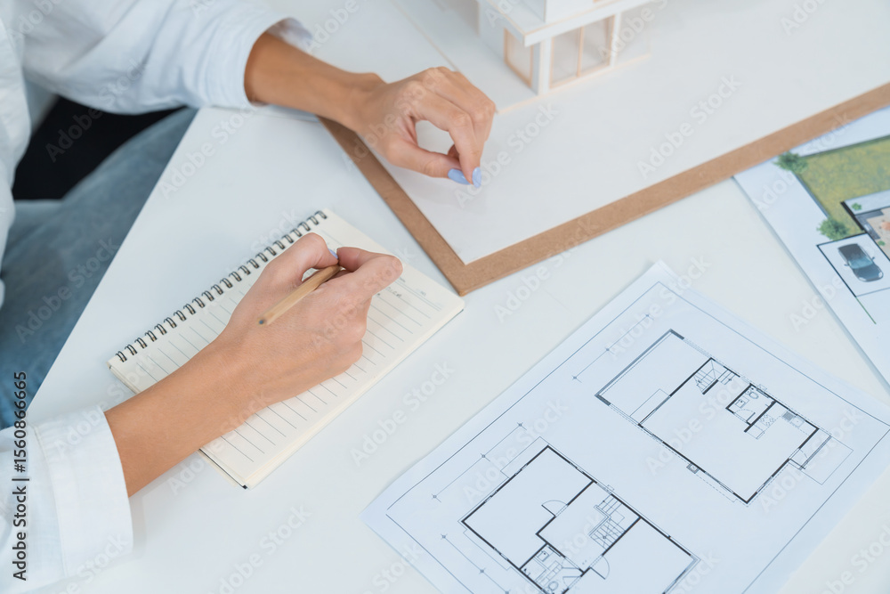 Poster top view image of professional beautiful young architect hand drafts blueprint while asian cooperati