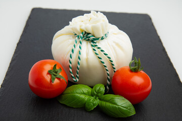 Burrata cheese with tomatoes and basil – front view