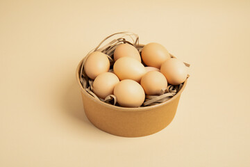 Brown eggs in round cardboard box – top view