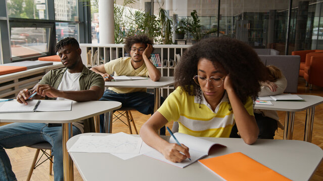 University high school students college lecture class lesson sad boring African American guys males men boys Caucasian girls women females ladies boredom suffer listening teacher study bored education