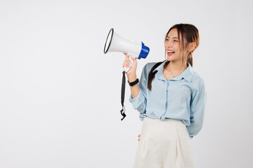 Excited young Asian woman holding a megaphone, speaking and making an announcement. She loves to scream and shout for promotion using this powerful megaphone. isolated studio white background