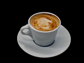 A white coffee cup with a brown foam on top