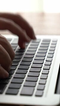 Businessman hand work on capable laptop computer at office table close up shot and selective focus at middle section of laptop computer keyboard while typing and working