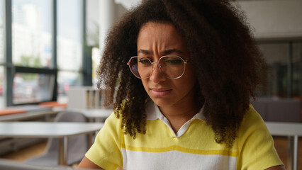 Confused shocked African American woman student girl ethnic female problem reading bad news loose...