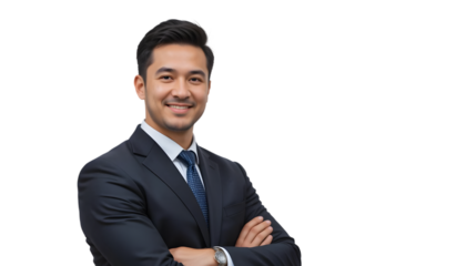Smiling Asian businessman in suit poses confidently with arms crossed against transparent backdrop, embodying success and leadership