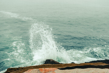 Looking down at waves crashing into Acadia National Park's shore.