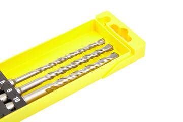 Three silver SDS-Plus masonry drill bits with spiral flutes and quick-change shanks, isolated on...