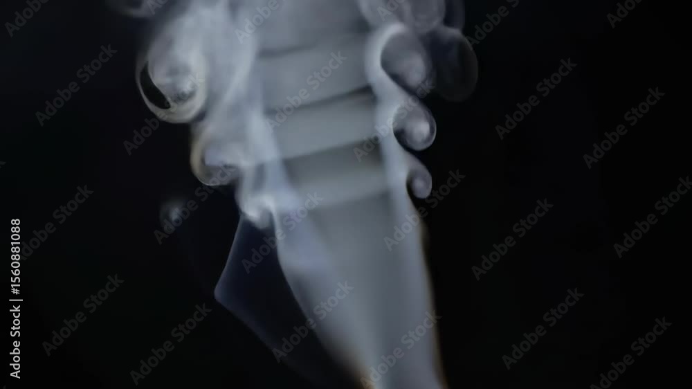 Aufkleber swirling smoke forms intricate patterns against a dark background, creating a mesmerizing visual eff