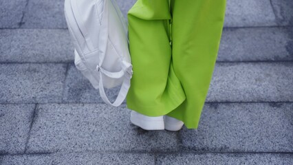 Close up photo of woman resting outside, going to walk
