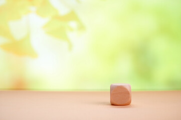 Single wooden block in field showing simplicity in financial planning, growth, and investment with...