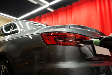 High-pressure air is directed at tight vehicle seams to remove lingering water after washing,...