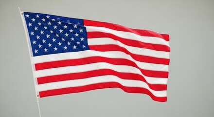 Fototapeta premium Full View of the US Flag Waving in a Light Grey Sky