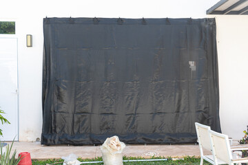 Hurricane tarpaulin placed on the windows of a house to protect against the arrival of a cyclone.