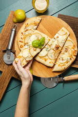 Pear pizza on a green background