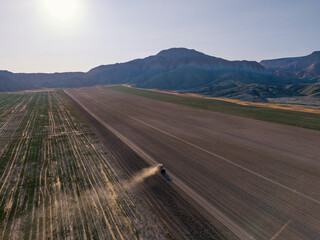 Nallihan Bird Sanctuary Beypazari Ankara Turkey Aerial view of a tractor working a field, preparing for planting. An expansive, flat agricultural field is depicted from a high-altitude perspective.