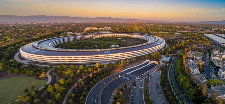 Aerial view of Apple Park, the corporate headquarters of Apple. The circular building is surrounded by trees and landscaping. Apple Park, Cupertino, California, USA. 21 April 2024.