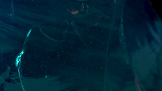 Geological wonder captured in motion - raw crystal with neon inclusions against dark void