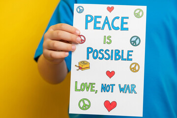 Hand holding colorful motivational card with peace message