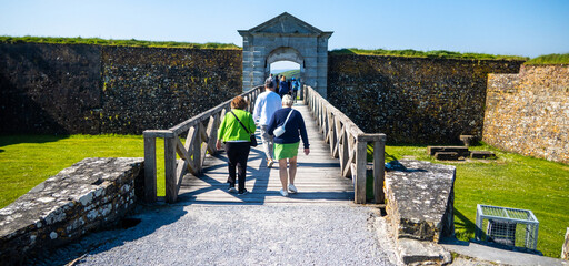 Kinsale, Ireland, May 20, 2024: Charles Fort British Fortress Ruins on Kinsale Bay with Rock Walls and Ramparts as visitors walk in the entrance