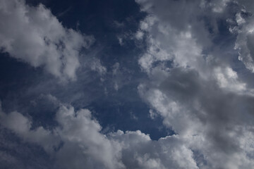 Puffy white clouds against a blue sky