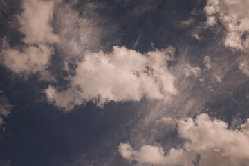 Puffy white clouds against a blue sky