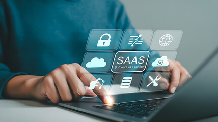 Person interacting with saas interface on laptop with cloud and security icons overlayed