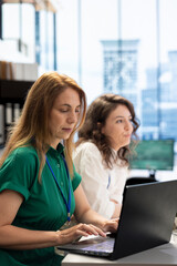 Recruiters typing on keyboard after candidate qualifications aligned with company expectations. HR...