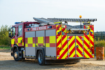 British red fire truck with hi-viz chevrons and battenberg