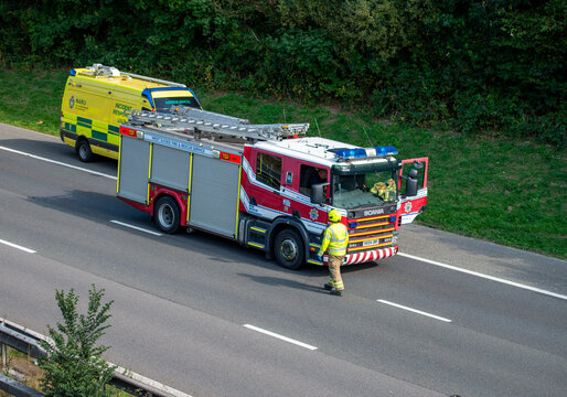 West Sussex fire and rescue fire truck on the road with ambulance behind