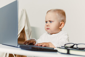 A Focused Baby Typing on a Laptop The Emergence of the Next Generation of Passionate Tech...