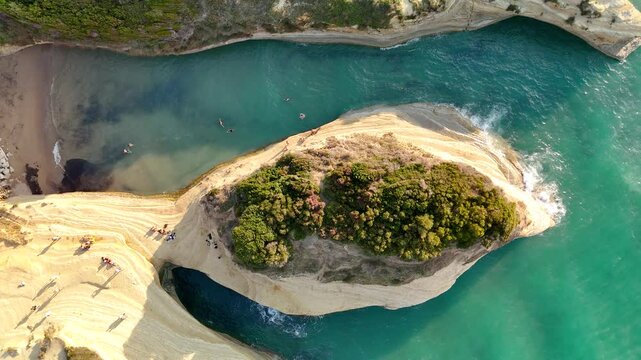 Drone landscape of sea waves splashing coast rock formations at sunset. Aerial top view of Canal d'Amour beach in Sidari Corfu, Greece