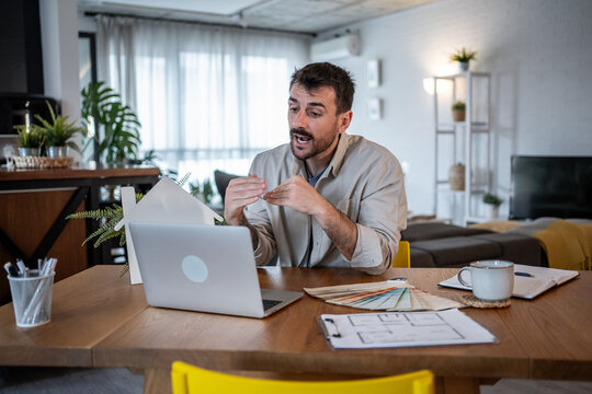 Architect presenting new house design during online meeting at home office