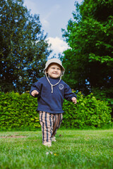 A joyful toddler is happily exploring the wonders of nature in a bright, sunny outdoor setting...