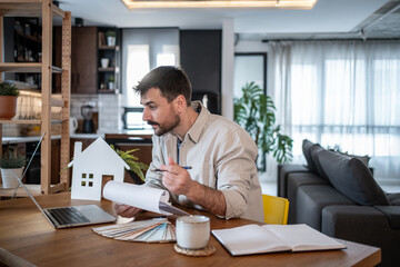 Architect working from home designing new house model