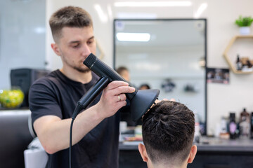 Professional Barber Finishing Haircut with Blow Dry at Local Small Business Barbershop.  Barber...