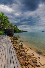 Wooden boardwalk at one of the hotels under a gloomy dramatic sky