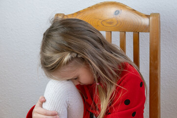 little child 5 years old in tears, blonde girl cries, covering face, early diagnosis and...