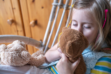 little child, preschool girl 5 years old plays with toy, hugs teddy bear, happy childhood,...