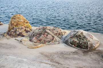 Vibrant fishing nets and buoys piled on a dock, ready for the sea, closeup