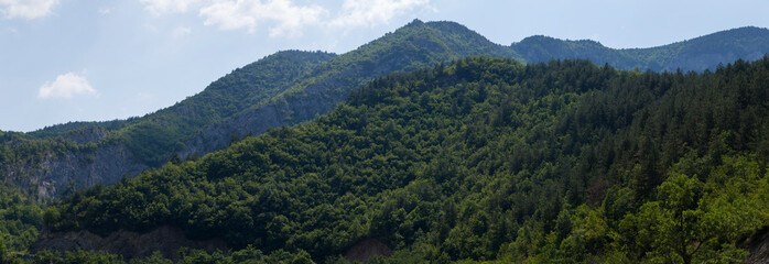 Rhodopes, are a mountain range in Southeastern Europe. Bulgaria. Panorama. The forest area covers...