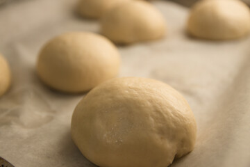 Close-up of a baking tray with homemade hamburger bun balls