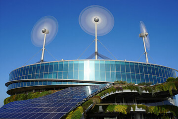 Modern glass and steel business tower against a blue sky, reflecting the city's urban architecture