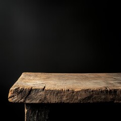 Rustic wooden table against black background