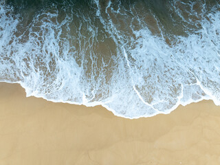 Top view of Fine sand texture natural background Waves crashing on sand Summer and travel background